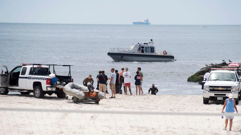 Police divers search for the body of the 10-year-old boy...