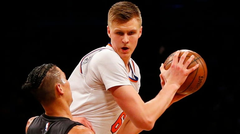 Kristaps Porzingis of the New York Knicks controls the ball...