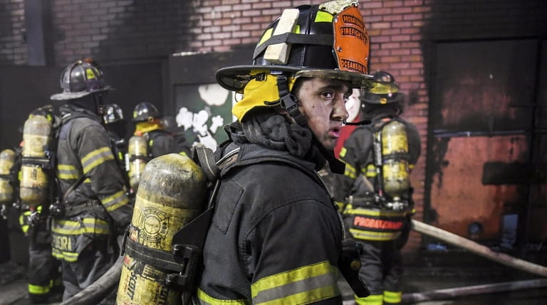 Volunteer firefighter Sattwa Conrad, from the Oceanside Fire Department, trains on a...
