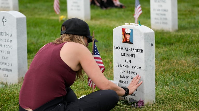 Krista Meinert touches the headstone of her son U.S. Marine...