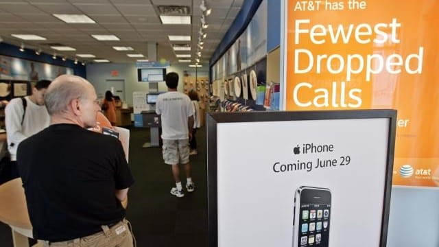 Customers shop at an AT&T store in Palo Alto, Calif....