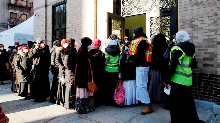 Mourners line up Sunday morning to enter the funeral service for...