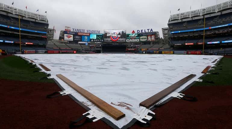 The tarp covers the field before the Opening Day game...