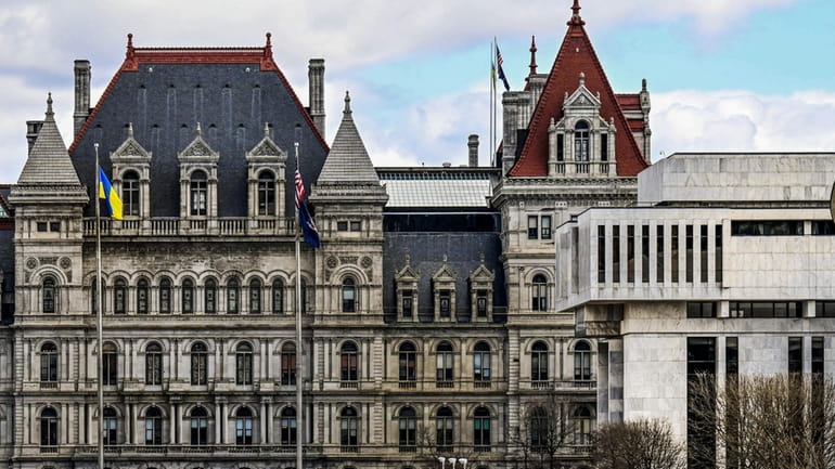 The New York State Capitol building, left, next to the...