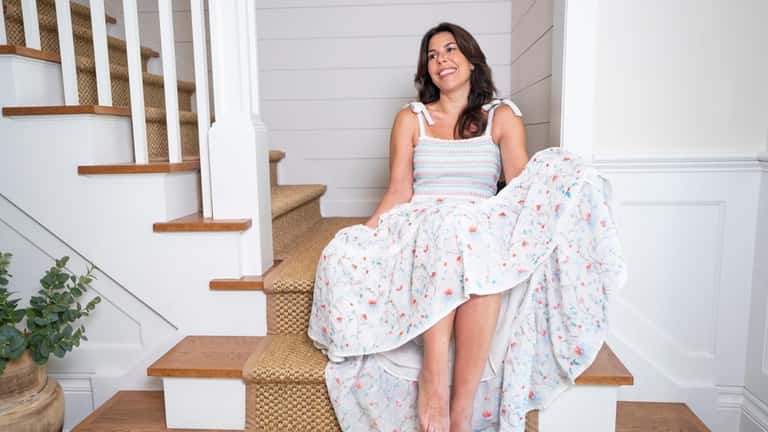 Joanna Mazzella, 42, sits by her shiplap staircase in Southold...