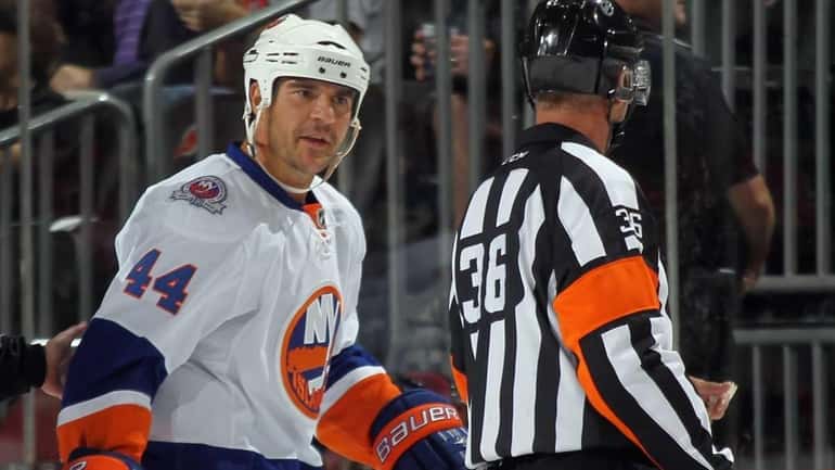Steve Staios #44 of the New York Islanders argues a...
