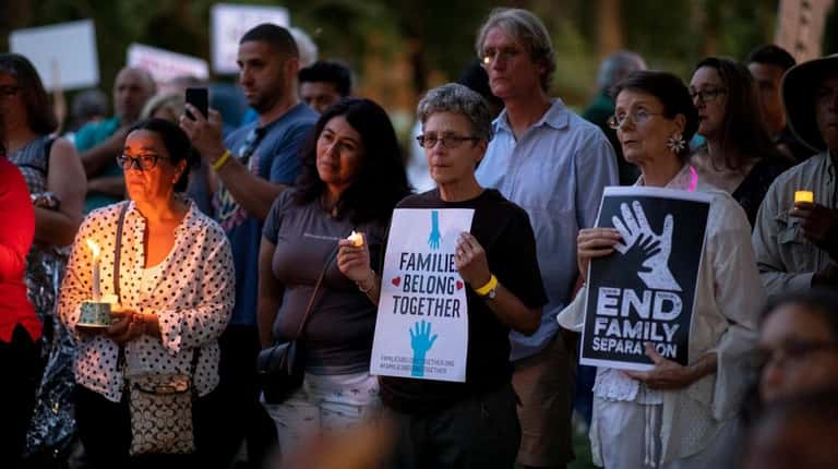 Huntington residents attend "Lights for Liberty: A Vigil to End...