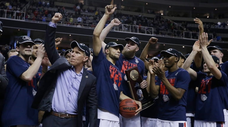 Gonzaga players and coach Mark Few, second from left, celebrate...