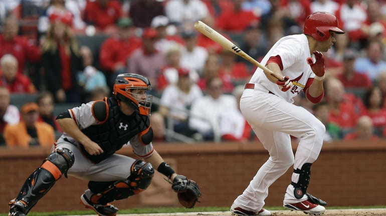 St. Louis Cardinals outfielder Carlos Beltran hits into a double...