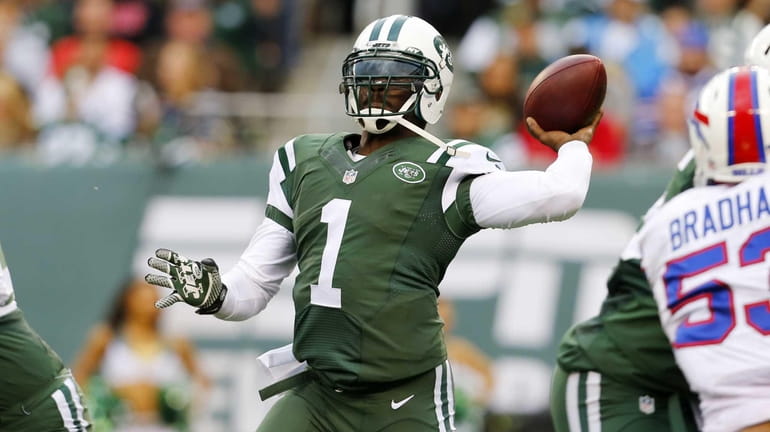 Michael Vick of the Jets throws a pass in the...