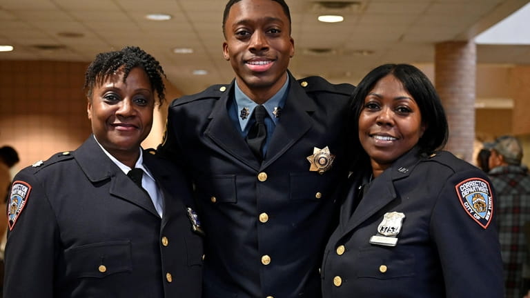 Newly graduated Suffolk County Corrections Officer Jaylin Smith, center, makes...