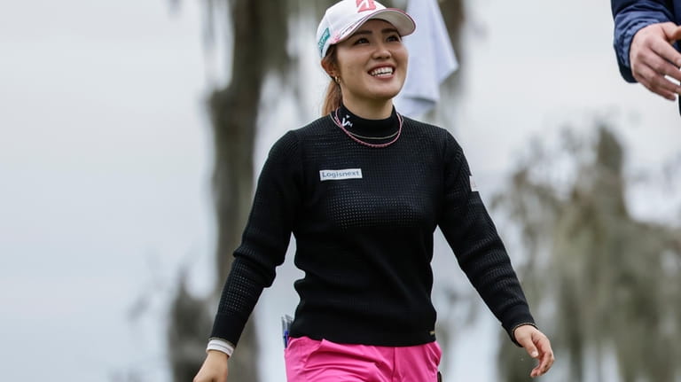 Ayaka Furue smiles after putting on the 18th green during...