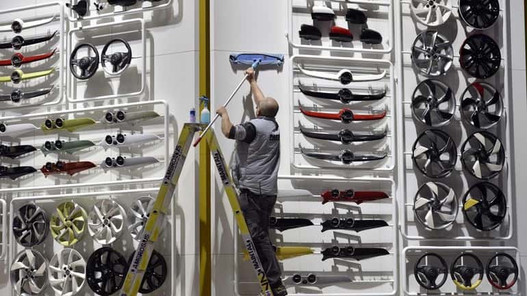 A worker cleans at the Opel booth during the last...