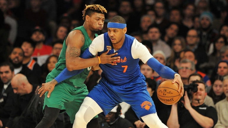 Carmelo Anthony of the Knicks is guarded closely by Marcus...