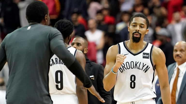 The Nets' Spencer Dinwiddie celebrates with teammates after defeating the...