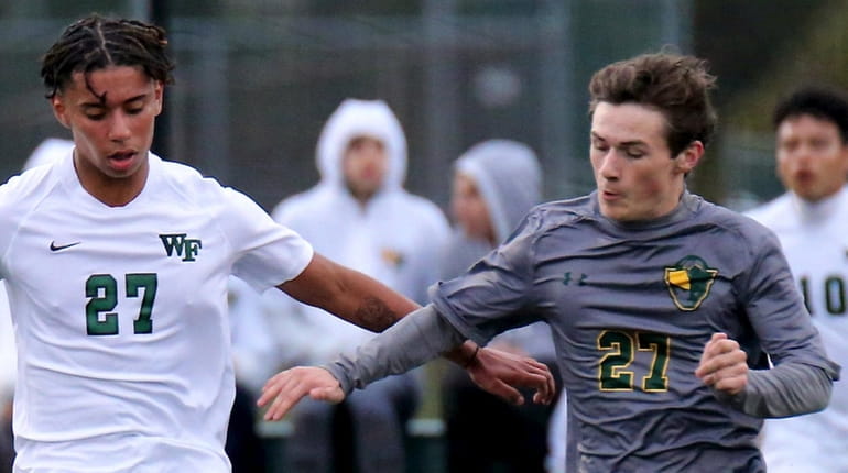 Floyd's Jovanny Ortiz and Ward Melville's Sean LaPeters battle for control...