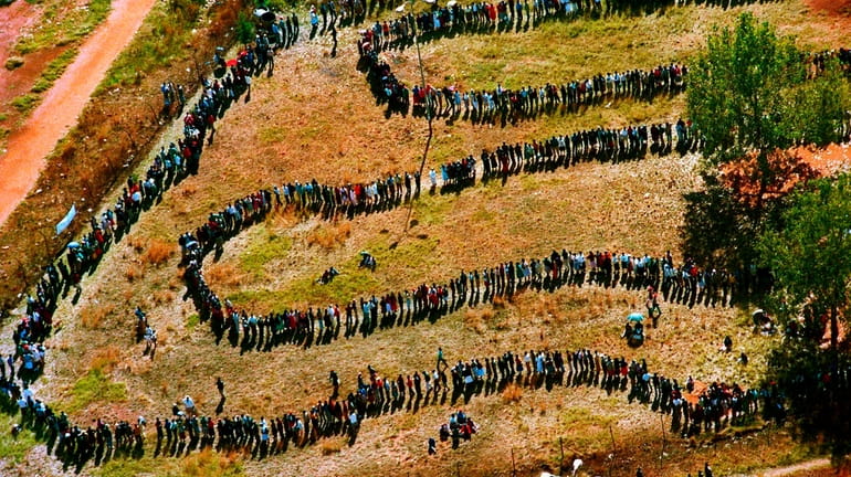 People queue to cast their votes In Soweto, South Africa...
