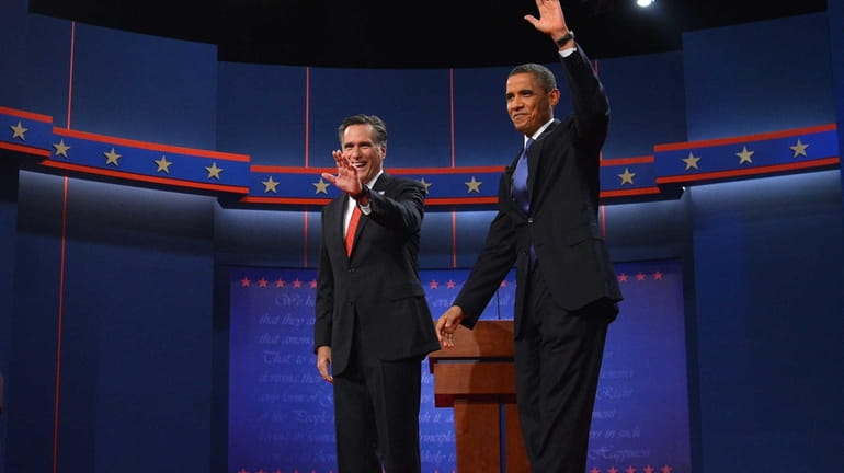 President Barack Obama and Republican challenger Mitt Romney wave before...