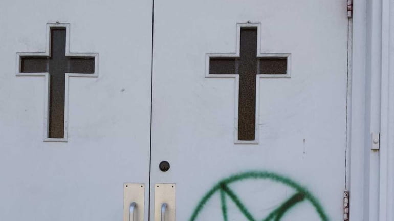 A pentagram scrawled on the front doors Bethel Assembly of...