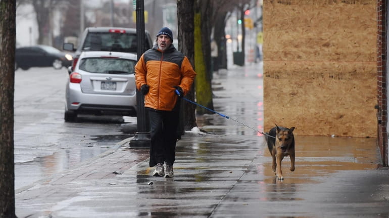 Frank Porfido, of Patchogue, runs with his dog Louie along...