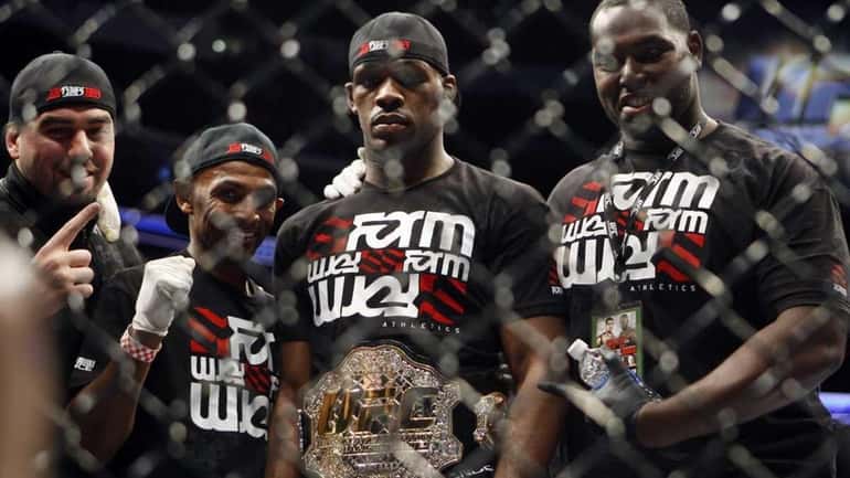 Jon Jones, second right, stands with others wearing a light...