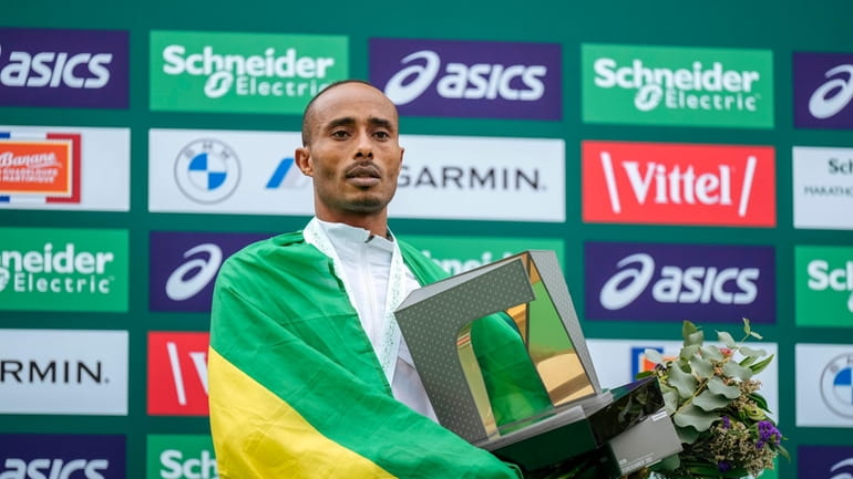 Uma Mulugeta of Ethiopia poses on the podium, after winning...