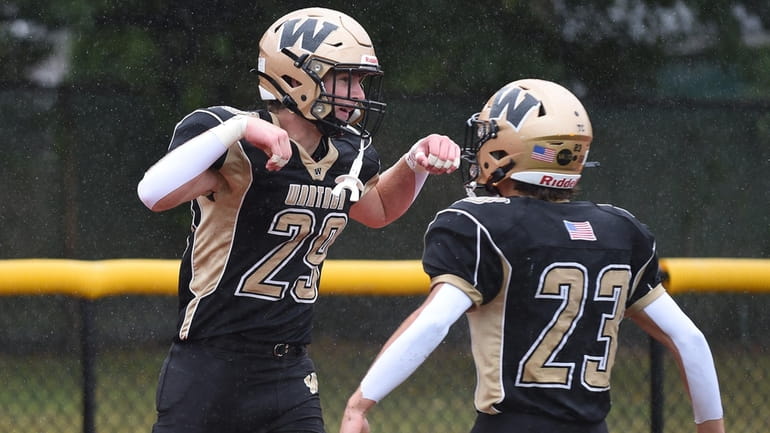 Jake Martini, Wantagh running back, left, gets congratulated by cousin...