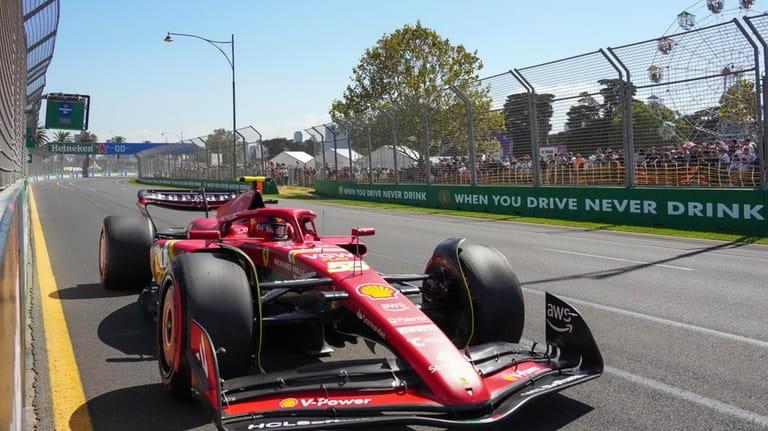 Ferrari driver Carlos Sainz of Spain steers his car during...