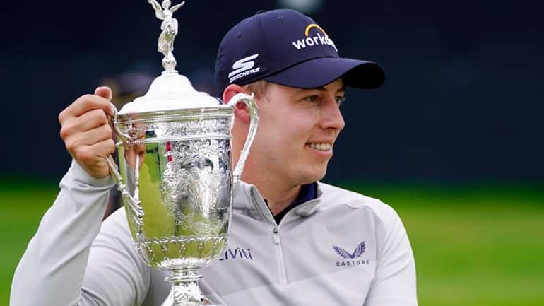 Matthew Fitzpatrick, of England, poses with the trophy after winning...