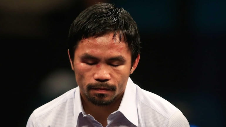 Manny Pacquiao answers questions during the post-fight news conference after...
