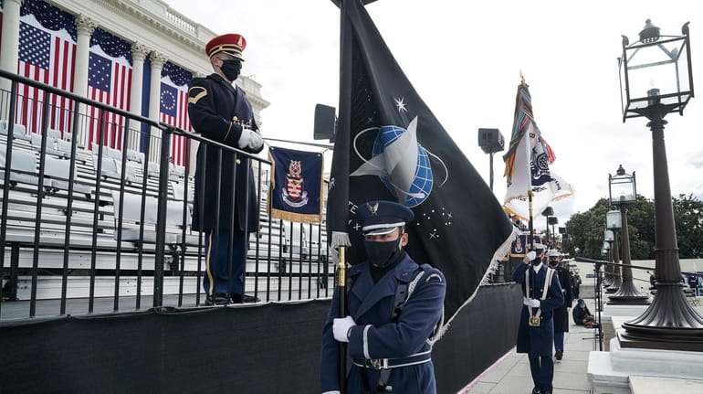 An honor guard member holds a Space Force flag during...