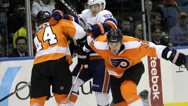 Philadelphia Flyers' Kimmo Timonen, left, blocks New York Islanders' Blake...