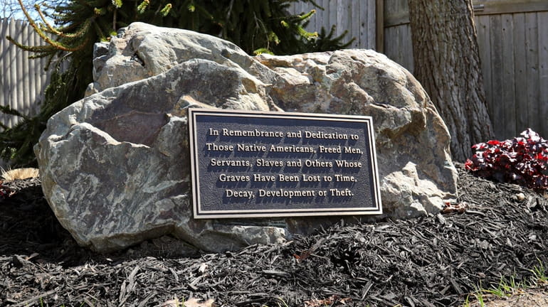 A memorial rock on the grounds of St. John's Episcopal Church in...