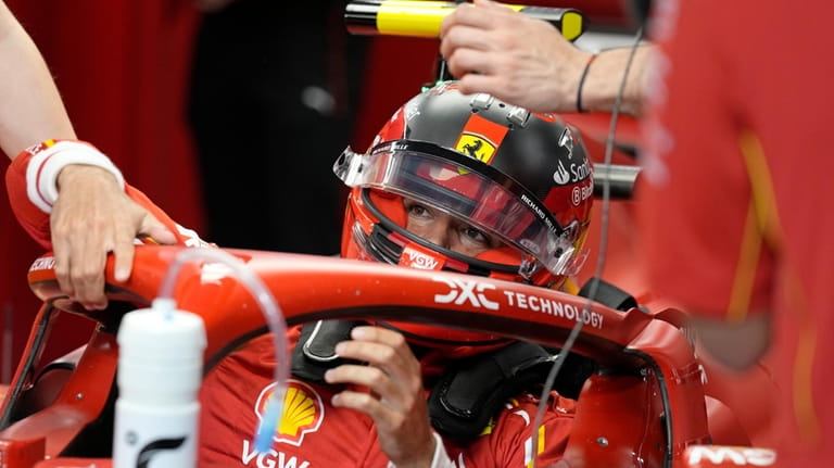 Ferrari driver Carlos Sainz of Spain sits in his car...