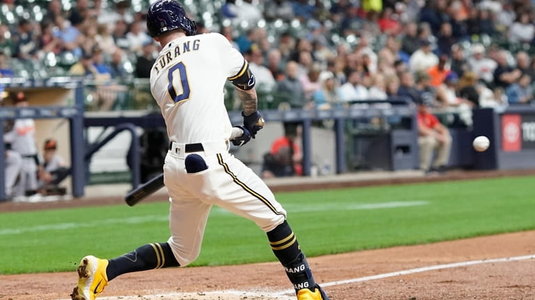 Milwaukee Brewers' Brice Turang hits a triple during the fourth...