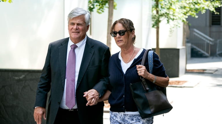 Dean Skelos and his wife Gail walk from the federal...