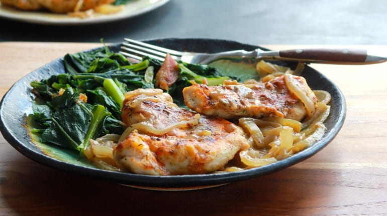 Chicken breasts are pan seared and served smothered in slow-cooked...
