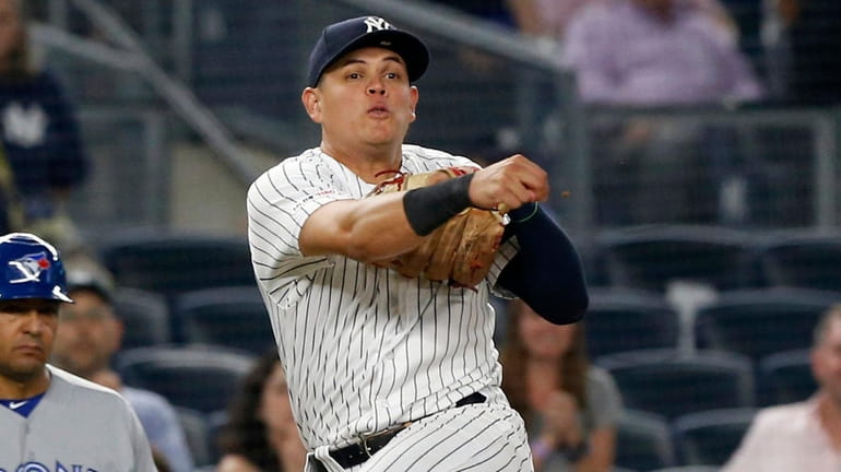 Yankees third baseman Gio Urshela throws for the final out...