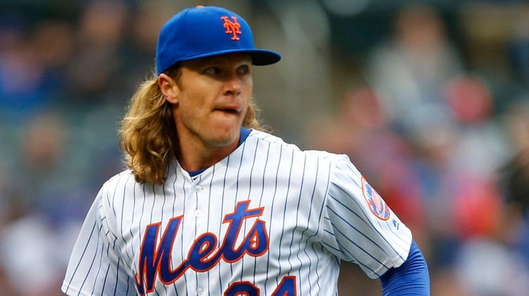 Mets pitcher Noah Syndergaard looks on after the first inning...