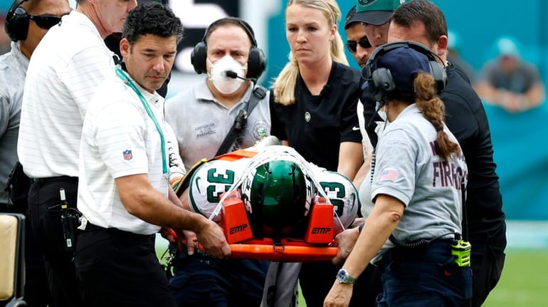 Elijah Riley is carted off in Miami after suffering a...
