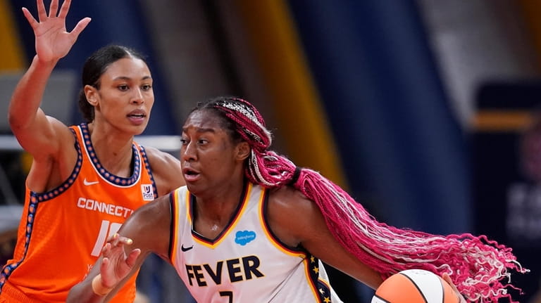 Indiana Fever's Aliyah Boston (7) is defended by Connecticut Sun's...