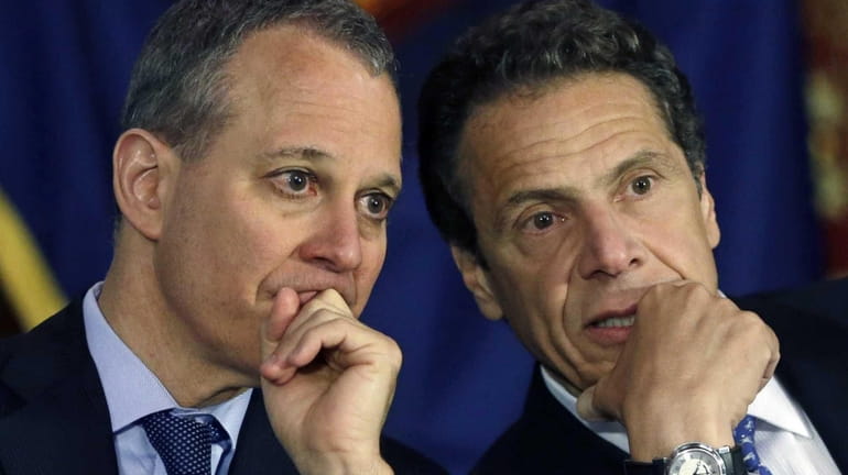 New York Gov. Andrew Cuomo, right, and New York Attorney...