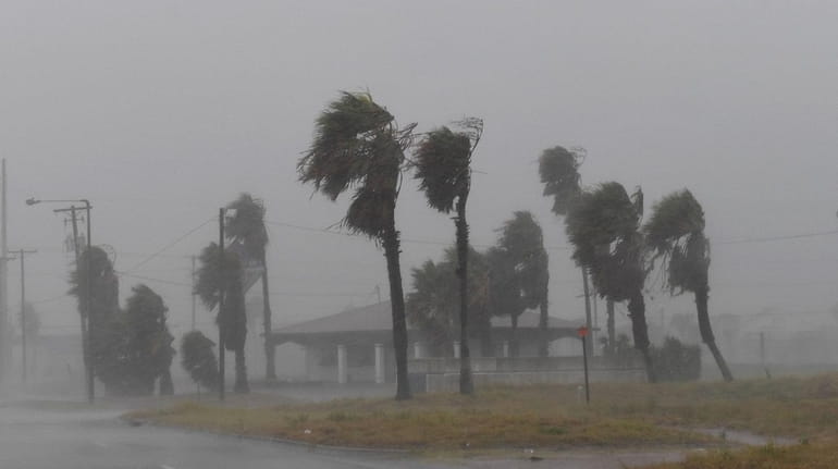 Strong winds batter a house on Padre Island before the...