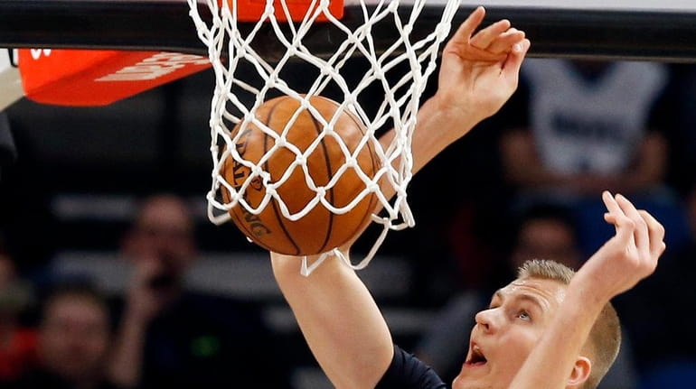 New York Knicks' Kristaps Porzingis of Latvia dunks as Minnesota...