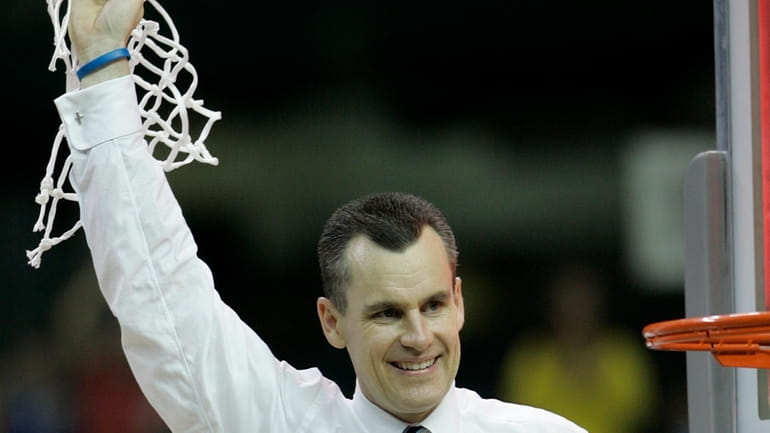 Florida coach Billy Donovan cuts down the net after his...