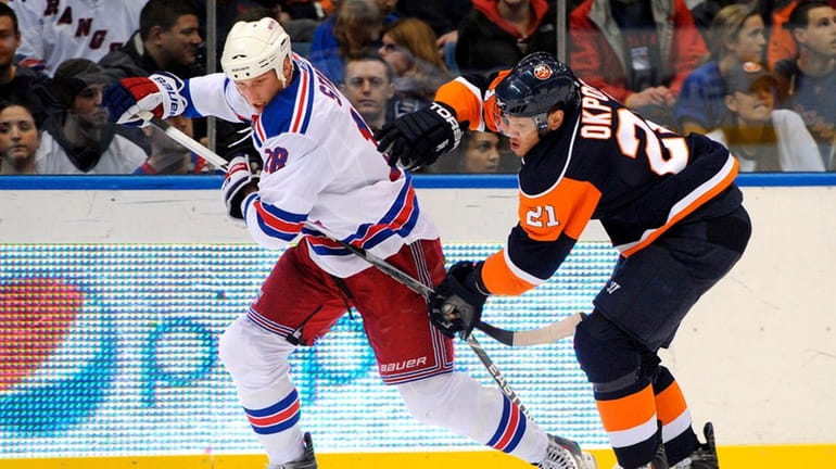 Rangers defenseman Marc Staal is chased by Kyle Okposo.