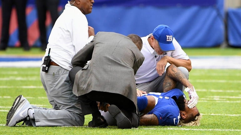 Giants wide receiver Odell Beckham Jr. is tended to on...
