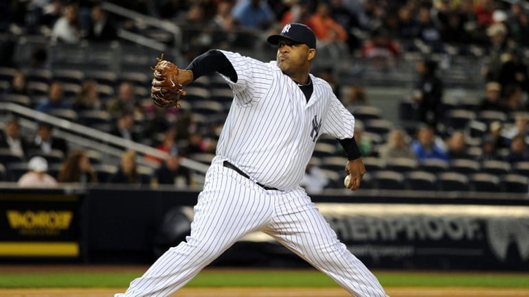New York Yankees starting pitcher CC Sabathia (52) pitches during...