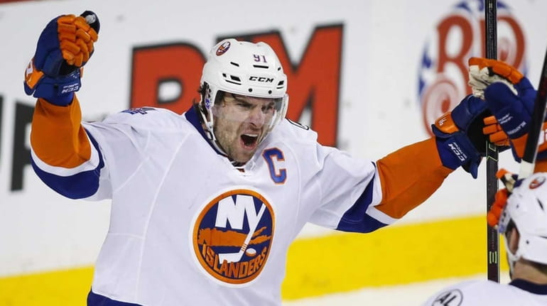 New York Islanders' John Tavares, left, celebrates with teammates Josh...