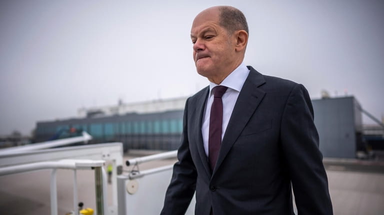 German Chancellor Olaf Scholz boards an Airbus of the Air...